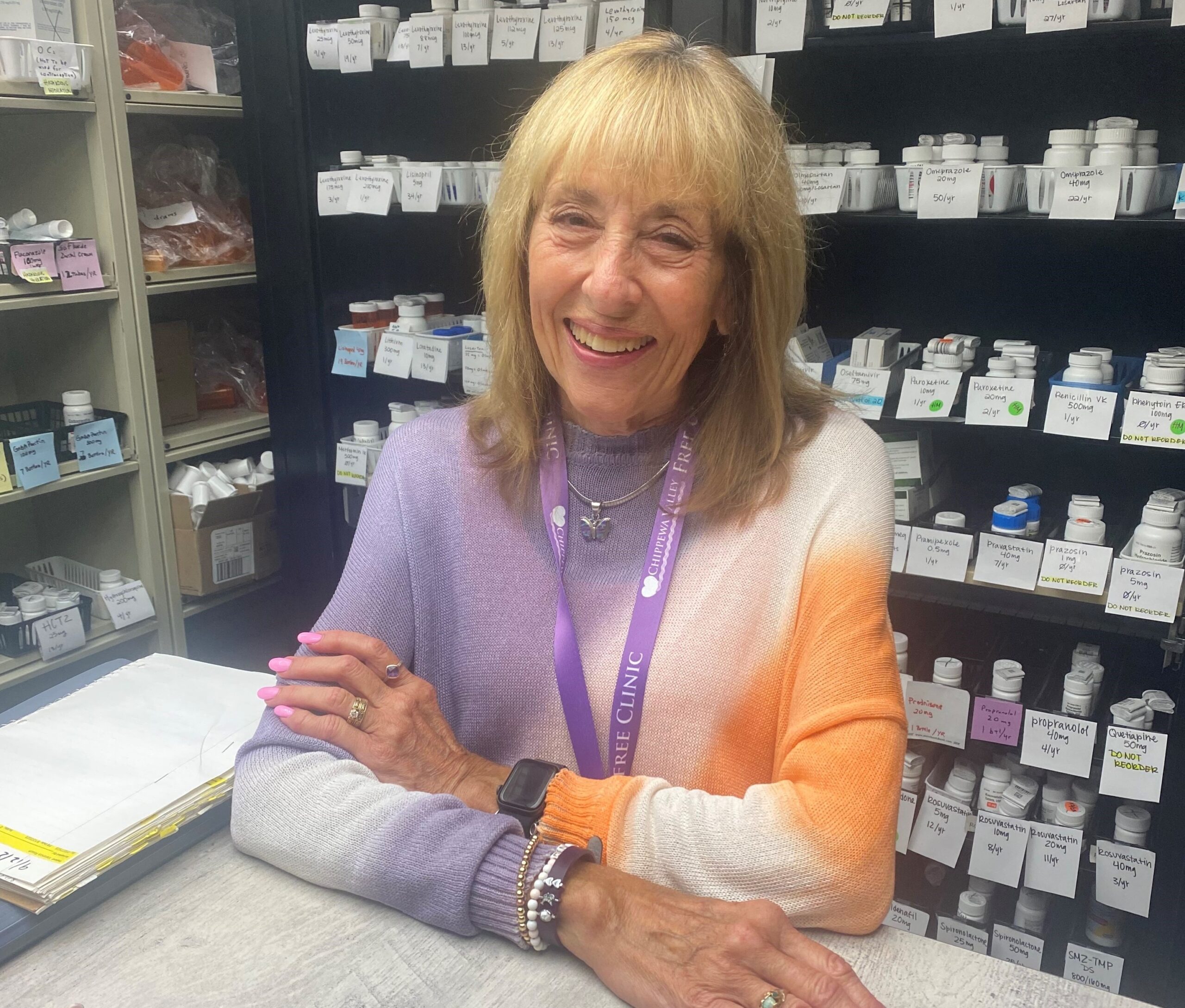 Smiling woman with blonde hair working in a pharmacy